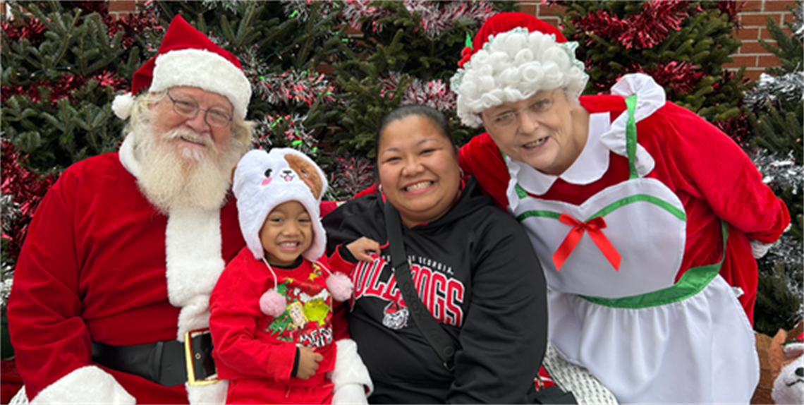 Santa and Mrs. Claus with a child and their mother
